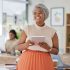 Tablet, work and happy smile of a Muslim black woman in a digital marketing office. International, global and diversity of company with a web market tech worker from Senegal with Islamic hair wrap.